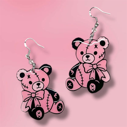 Pink and black teddy bear beaded resin statement earrings on a pink background