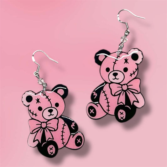 Pink and black teddy bear beaded resin statement earrings on a pink background