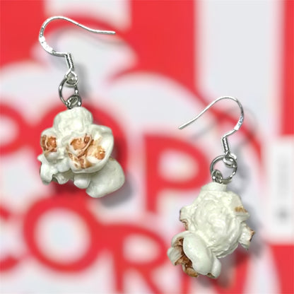 Plain popcorn dangle earrings on a red and white popcorn bucket background