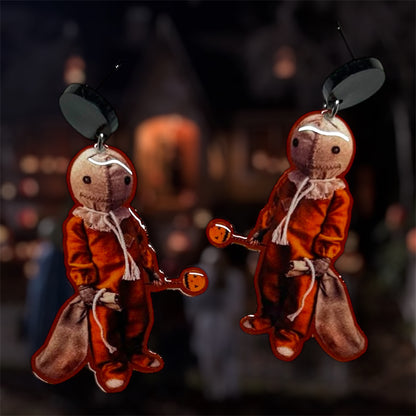 Trick-r-Treat Sam with lollipop resin dangle earrings on a blurred background
