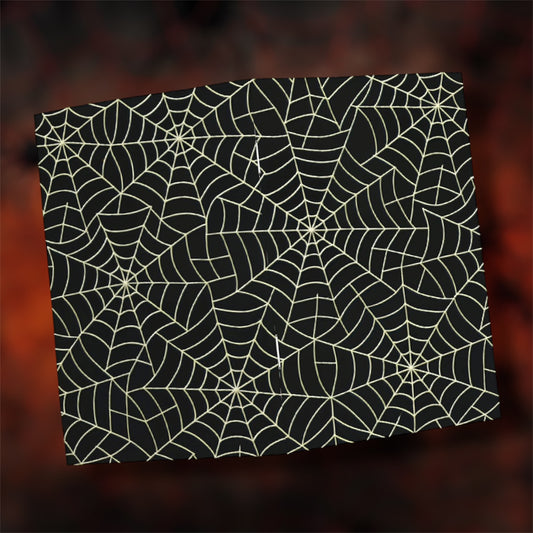 Open black and white spiderweb notebook on a blurry red and black background