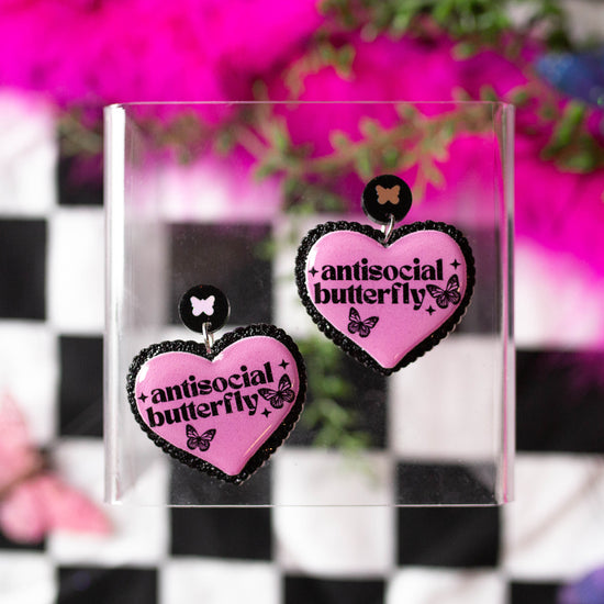 Antisocial butterfly heart-shaped resin statement earrings